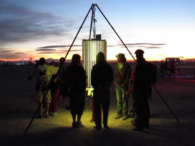 Strange Attractor LED cylinder at night with blue and purple lights